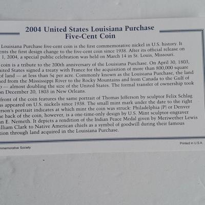 Two unopened 2004 United States Louisianna Purchase Five-Cent coins and a Lincoln - Kennedy Penny