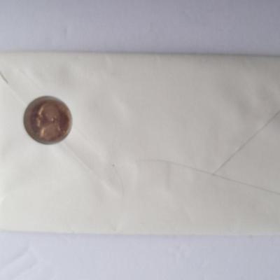 Two unopened 2004 United States Louisianna Purchase Five-Cent coins and a Lincoln - Kennedy Penny