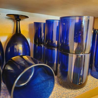 Collection of Blue Glasses Middle Shelf of Cabinet