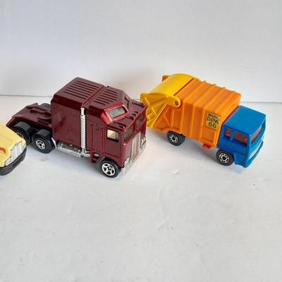 Two Semi Trucks one with trailer Road Champs, and Hot Wheels, and Matchbox Refuse Truck