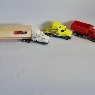 Two Semi Trucks one with trailer Road Champs, and Hot Wheels, and Hot Wheels Dump Truck