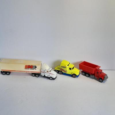 Two Semi Trucks one with trailer Road Champs, and Hot Wheels, and Hot Wheels Dump Truck