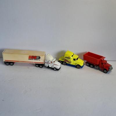 Two Semi Trucks one with trailer Road Champs, and Hot Wheels, and Hot Wheels Dump Truck