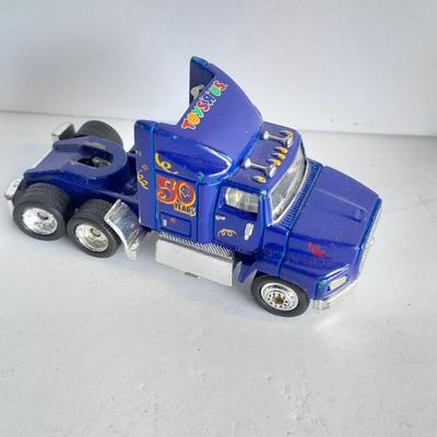 Three advertisement Semi Trucks and one trailer Road Champs, and Matchbox,