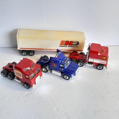Three advertisement Semi Trucks and one trailer Road Champs, and Matchbox,