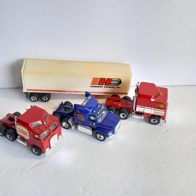 Three advertisement Semi Trucks and one trailer Road Champs, and Matchbox,