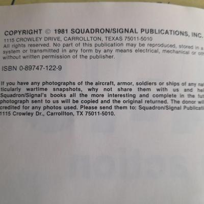 Military books, Field Guide booklets, and a Side cap