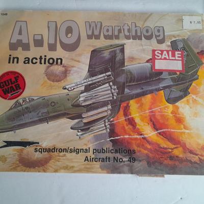 Military books, Field Guide booklets, and a Side cap