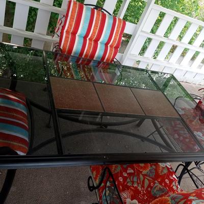 PATIO TABLE WITH 4 ARMED IRON ROCKING CHAIRS WITH LIKE NEW CUSHIONS