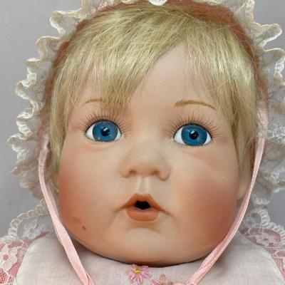 Porcelain Bisque Soft Body Baby Doll Blond Hair Blue Eyed Girl in Pink Outfit