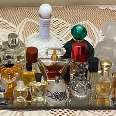 Perfume And Perfume Bottles On Mirrored Tray