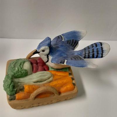 Decorative Noah's Ark Tea pot, Wooden salt & pepper mills, and a Blue Jay figure stealing vegetables.