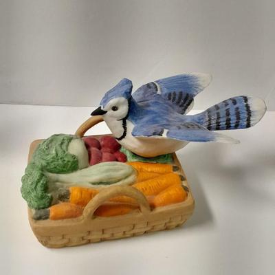 Decorative Noah's Ark Tea pot, Wooden salt & pepper mills, and a Blue Jay figure stealing vegetables.