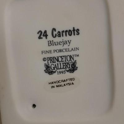 Decorative Noah's Ark Tea pot, Wooden salt & pepper mills, and a Blue Jay figure stealing vegetables.