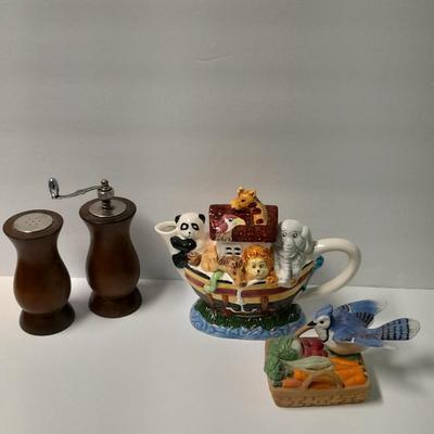 Decorative Noah's Ark Tea pot, Wooden salt & pepper mills, and a Blue Jay figure stealing vegetables.