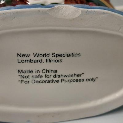 Decorative Noah's Ark Tea pot, Wooden salt & pepper mills, and a Blue Jay figure stealing vegetables.