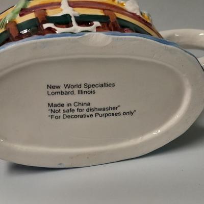 Decorative Noah's Ark Tea pot, Wooden salt & pepper mills, and a Blue Jay figure stealing vegetables.