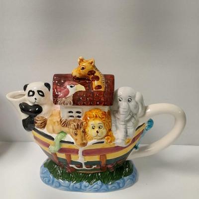 Decorative Noah's Ark Tea pot, Wooden salt & pepper mills, and a Blue Jay figure stealing vegetables.