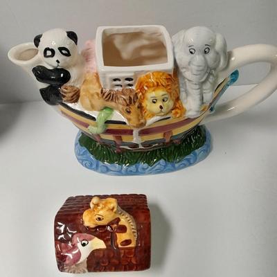 Decorative Noah's Ark Tea pot, Wooden salt & pepper mills, and a Blue Jay figure stealing vegetables.