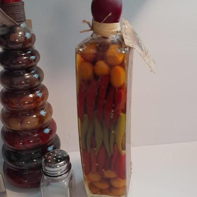 Decorative bottles of oil & vinegars a small platter and salt & pepper shakers