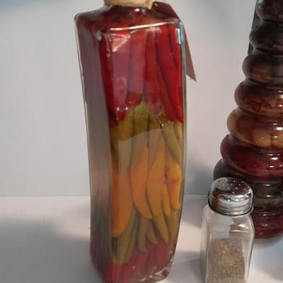 Decorative bottles of oil & vinegars a small platter and salt & pepper shakers