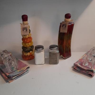 Decorative oil bottles, salt & pepper shakers, linen floral napkins with napkin rings