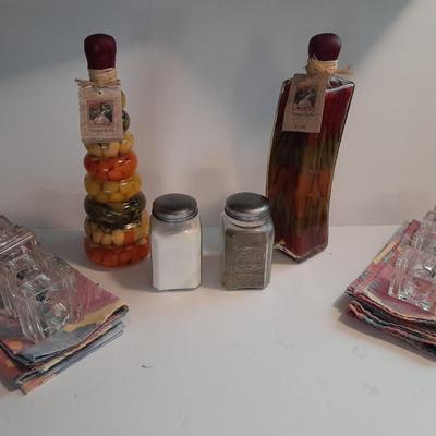 Decorative oil bottles, salt & pepper shakers, linen floral napkins with napkin rings