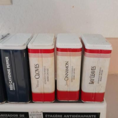 Nonskid Shelf organizer with metal cans of cooking spices