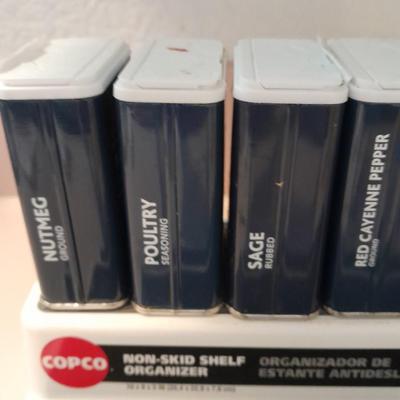 Nonskid Shelf organizer with metal cans of cooking spices