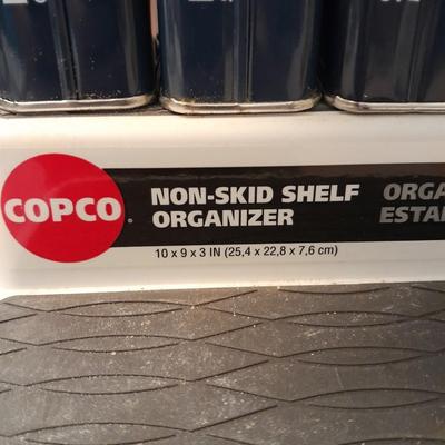 Nonskid Shelf organizer with metal cans of cooking spices