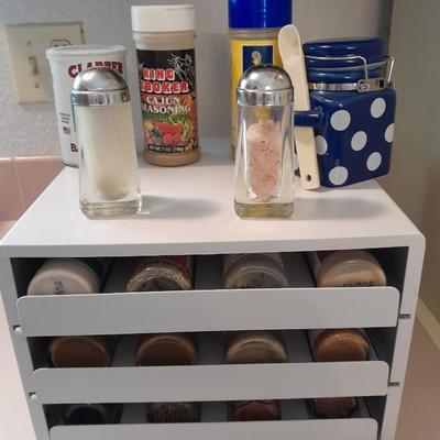 Plastic drawered Spice organizer with glass bottles of Spices