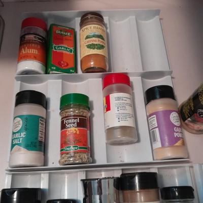 Plastic drawered Spice organizer with glass bottles of Spices