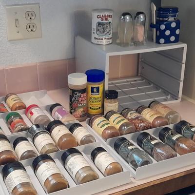 Plastic drawered Spice organizer with glass bottles of Spices