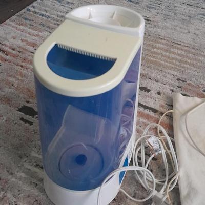 Vick's Humidifier, Glacier Bay shower head, and an electric heating pad