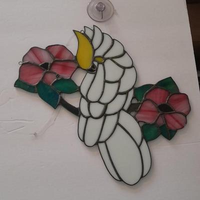 Stained glass window hangings and a small God bless the birds Tapestry.