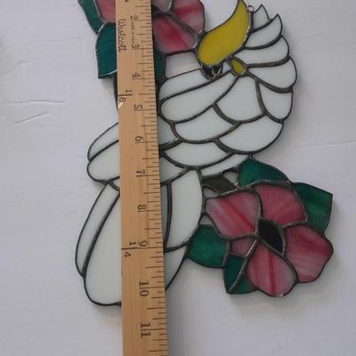 Stained glass window hangings and a small God bless the birds Tapestry.