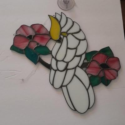 Stained glass window hangings and a small God bless the birds Tapestry.