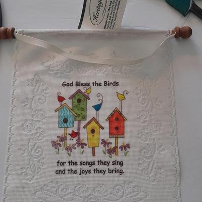 Stained glass window hangings and a small God bless the birds Tapestry.