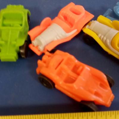 LOT 116  SEVEN PLASTIC CARS WITH A METAL BALL