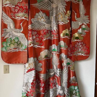 Beautiful red Japanese Uchikake ceremonial kimono featuring embroidered cranes.