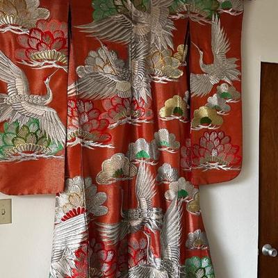 Beautiful red Japanese Uchikake ceremonial kimono featuring embroidered cranes.