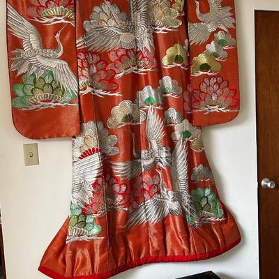 Beautiful red Japanese Uchikake ceremonial kimono featuring embroidered cranes.