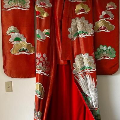 Beautiful red Japanese Uchikake ceremonial kimono featuring embroidered cranes.