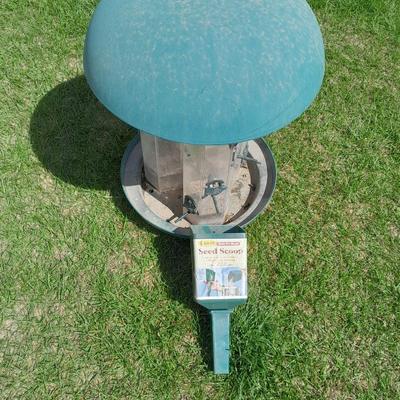 Large plastic bird feeder with bird feeder scoop