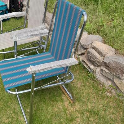 Two metal framed folding chairs