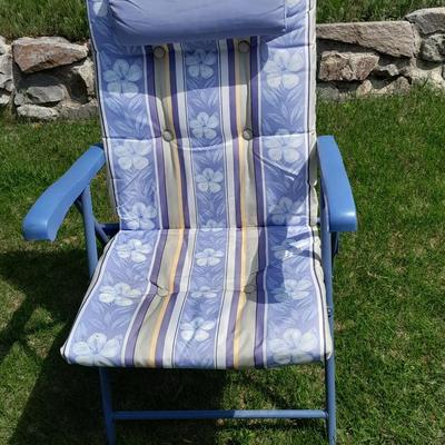 Folding metal framed folding chair with cushioned fabric and a 28 quart cooler