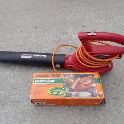 Electric Homelite leaf blower with extension cord and a controlled grass trimming tool