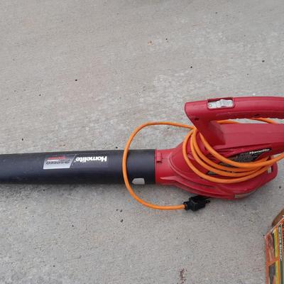 Electric Homelite leaf blower with extension cord and a controlled grass trimming tool