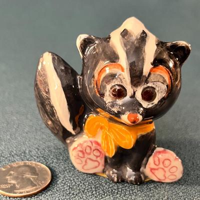 HAND MADE CERAMIC SKUNK FIGURINE 2-1/2â€ TALL.