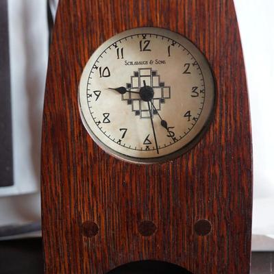 INTHE PRAIRIE STYLE. TWO FRAMED PAPER PRINTS IN BLACK FRAMES WITH WROUGHT IRON HANGER. FLW STYLE STATURE OF 8" & CLOCK FROM THE...